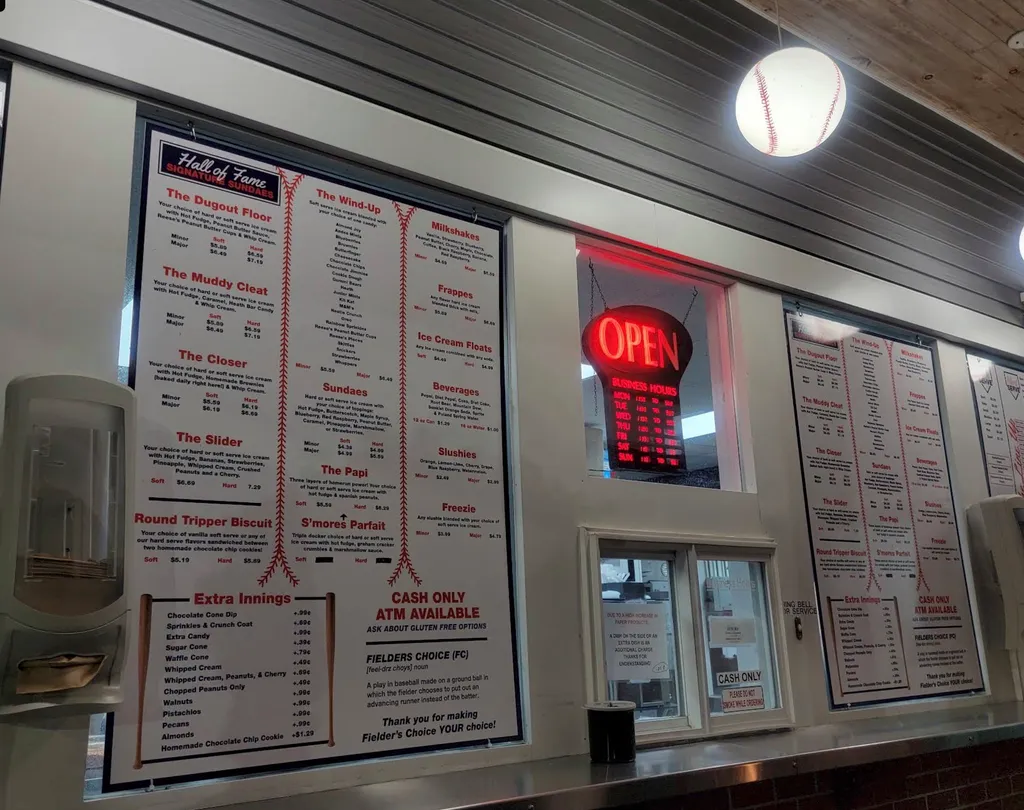 Menu board with open sign and cash only notice.